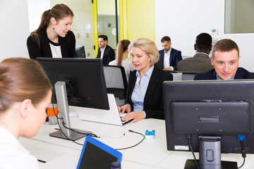 Coworkers engaged in open plan office