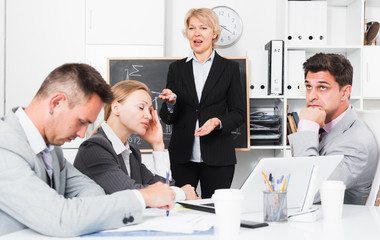 Businesswoman expressing dissatisfaction with work of colleagues
