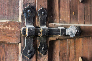 old ferrous lock on a wooden door..