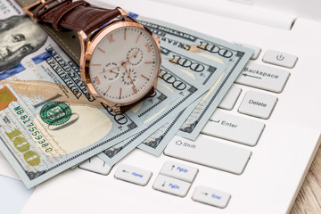 Concept time - money, dollar notes and hand watch