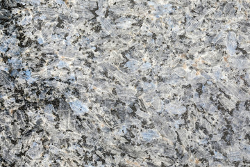 Granite, basalt or marble stone crystal texture of polished gravestone. The macro shot is made by means of stacking technology