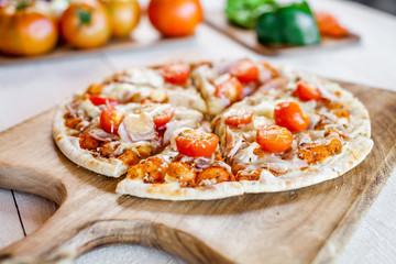 hot fresh homemade traditional italian pizza on wooden table. wallpaper for pizzeria and cooking food concept. closeup