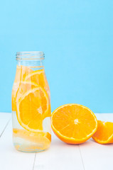 Fototapeta na wymiar Front view of glass bottle with a detox orange water