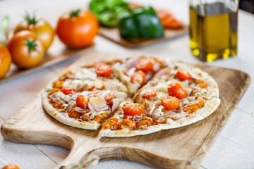 hot fresh homemade traditional italian pizza on wooden table. wallpaper for pizzeria and cooking food concept. closeup