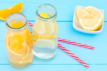 Close up top view of detox water in a glass bottles on a wooden background