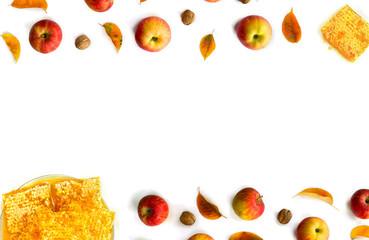Ripe yellow red juicy apples with leaves, honey, honeycombs and walnuts autumn on white background with space for text. Top view, flat lay