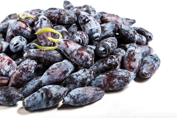 Pile of  Blue honeysuckle (Lonicera caerulea) or Haskap berry isolated on white background.