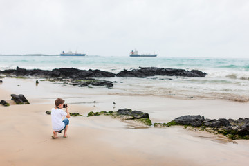 Little boy at rocky coast