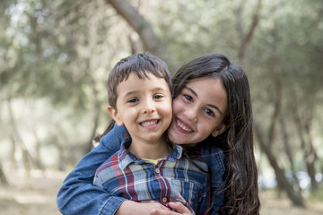 Girl and boy posing in the park