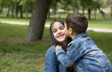 Girl and boy posing in the park