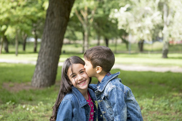 Girl and boy posing in the park