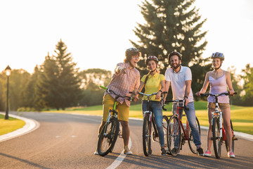 Fototapeta premium Group of young people on a bike trip. Group of joyful students on a bike ride. Spending qualitative time together.