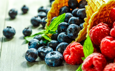 Berries in waffle cones grey background