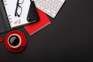 black background red coffee cup note pad alarm clock flower diary scores keyboard empty space desktop - Powered by Adobe