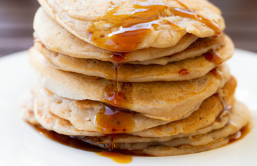 Close up of vegan buckwheat pancake tower with maple syrup