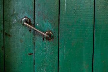 Old wooden green door with handle