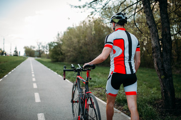 Fototapeta na wymiar Cyclist in helmet and sportswear rides on bicycle
