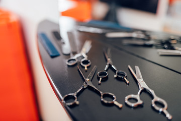 Scissors on wooden table in hairdressing salon