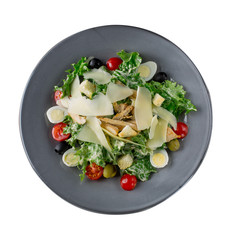 Caesar salad in a plate on a white background