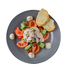 Salad with sauce in a plate with croutons on a white background