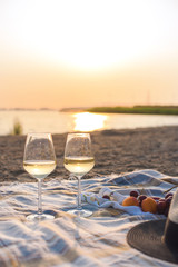 Picnic on the beach, romantic atmosphere. Sunset and dinner. Relax on the beach. Copy space.