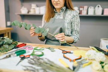 Fototapeta premium Female florist, bouquet preparation process