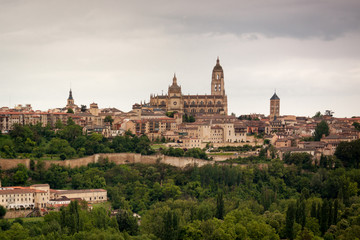 Fototapeta na wymiar viewpoint of Segovia. Gothic cathedral, Romanesque churches, aqueduct. Segovia skyline in spring, gray sky. Spain. Europe