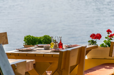 MONTENEGRO, BECICI - JUNE 05/2017: the restaurant staff prepared their tables near the sea for dinner during sunset