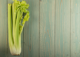 Celery stalks on wood background