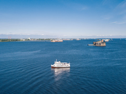 Aerial view of a small white passenger ship going along the Finnish Gulf 