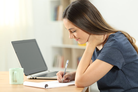 Single woman taking notes in a notebook