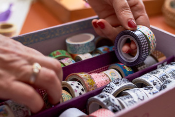 hands manipulating Washi tape collection