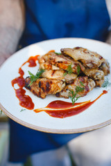 Chicken skewers on a plate with sauce