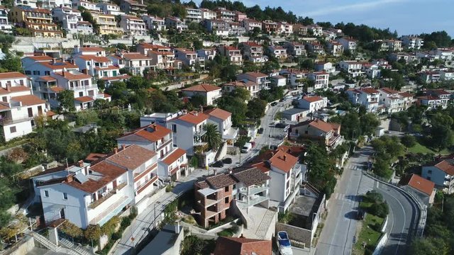 Drone shot flying over beautiful holiday homes and residential apartment buildings in Rabac town in Croatia