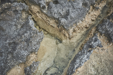 Top view close up steep ravine on rocky mountain. Risk and danger concept 