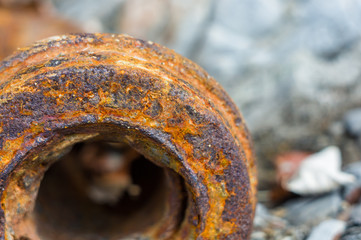 Very rusty metal on a gray cracked rock
