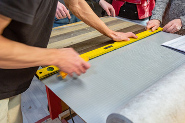 Carpenter doing his job in carpentry workshop. a man in a carpentry workshop measures and cuts laminate