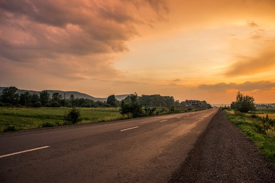 Orange Sunset Evening Country Side Landscape With Lonely Road Concep