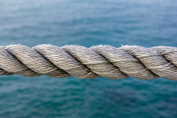 Fototapeta na wymiar old marine rope on the pebble beach