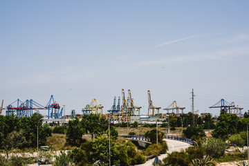 Fototapeta na wymiar Cranes of longshoremen in the seaport of Valencia in the Mediterranean