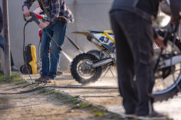 Fototapeta na wymiar Bike rider washing his motorcycle