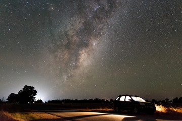 Milkyway above a parked car by a country road