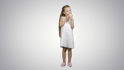 Kid girl eating ice cream on white background