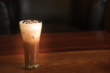 Iced coffee on a table with dark on background
