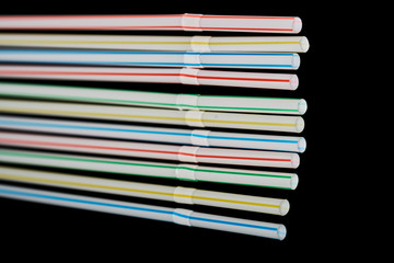 drinking straws on a black background