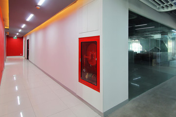 Emergency exit of the building with fire exit sign,fire alarm and Fire extinguisher