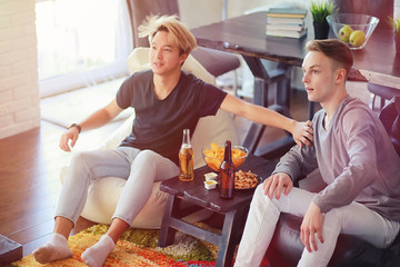 Watching a sports match with friends at home