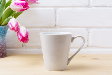 Fototapeta na wymiar White latte mug mockup with magenta tulip