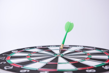 Fototapeta premium On the Target. Green dart hitting the target.
