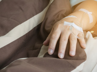 Focus on the hands of female patients in the hospital. And the salt water